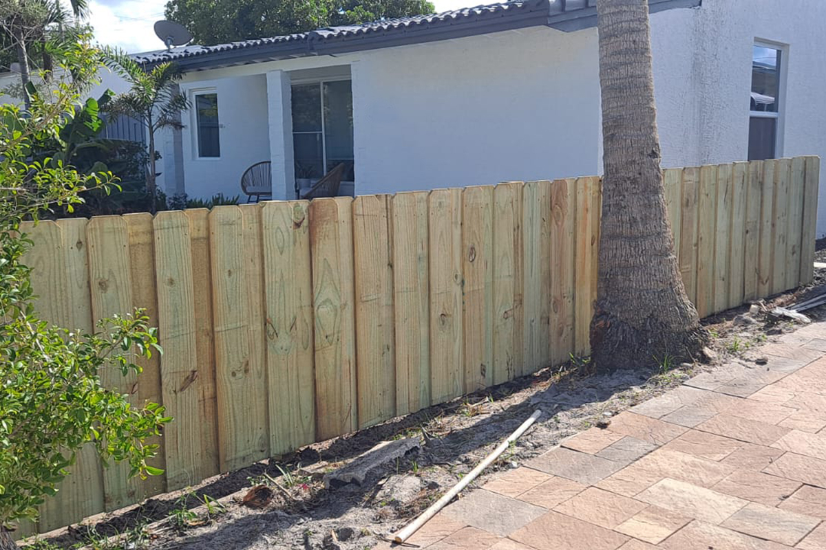 Close-up view of a newly installed board-on-board wood fence along a residential property in Oakland Park, FL, by Exclusive Custom Fence & Repairs.