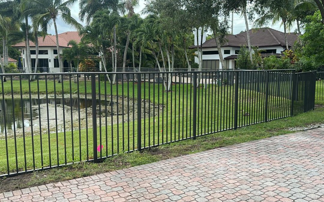 CF10 bronze mechanical aluminum fence installation along a waterfront property in Weston, Florida.